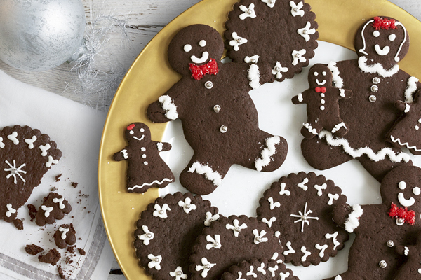 chocolate gingerbread man gingersnap cookies frosted on a plate