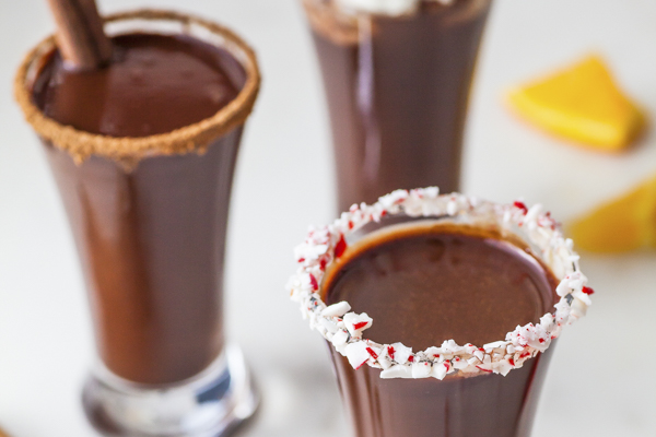 hot chocolate in shot glasses with crushed peppermints and chocolate powder
