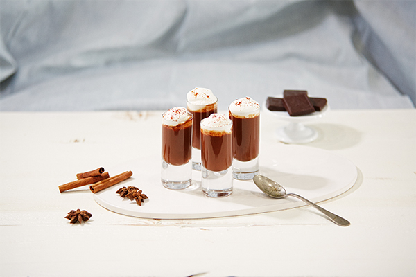 four mexican hot chocolate shooters in tall shot glasses on a table