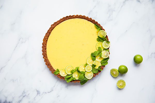 A top down view of a keylime pie with chocolate crust