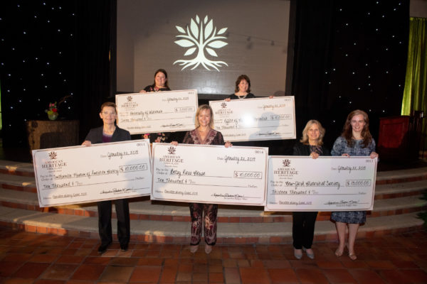 grant winners holding their checks from american heritage chocolate